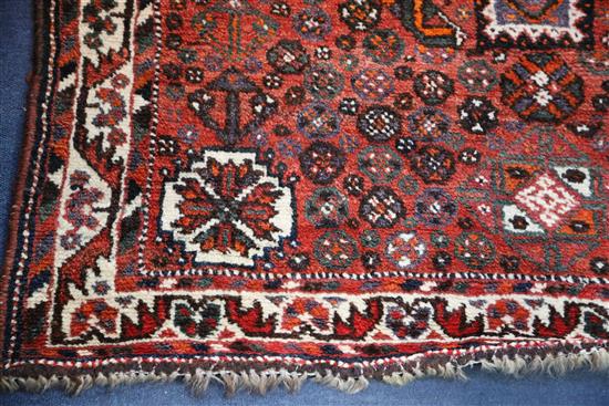 A Shiraz design red ground rug, 5ft 3in by 3ft 8in.